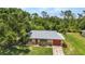 Charming single-story home with an attached garage and a well-maintained lawn at 1242 Orlando Blvd, Port Charlotte, FL 33952
