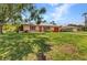 Charming single-story home with an attached garage and a well-maintained lawn at 1242 Orlando Blvd, Port Charlotte, FL 33952