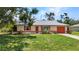 Charming single-story home with an attached garage and a well-maintained lawn at 1242 Orlando Blvd, Port Charlotte, FL 33952
