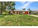 Charming single-story home with an attached garage and a well-maintained lawn at 1242 Orlando Blvd, Port Charlotte, FL 33952