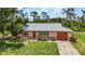 Charming single-story home with an attached garage and a well-maintained lawn at 1242 Orlando Blvd, Port Charlotte, FL 33952