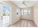 Bright sunroom featuring tile flooring, multiple windows, and a ceiling fan for optimal air circulation at 1242 Orlando Blvd, Port Charlotte, FL 33952