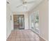 View of sunroom featuring tile flooring and sliding glass door with kitchen view at 1242 Orlando Blvd, Port Charlotte, FL 33952