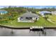 Aerial shot of a home with a private pool, dock, and lush landscaping on a waterfront canal at 12581 Eisenhower Dr, Port Charlotte, FL 33953