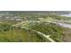 Aerial view of vacant lot surrounded by lush greenery and waterfront access at 12581 Eisenhower Dr, Port Charlotte, FL 33953