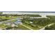 An aerial perspective of the property including the neighboring canal, river, with views of lush foliage and surrounding landscape at 12581 Eisenhower Dr, Port Charlotte, FL 33953