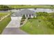 Expansive aerial view of waterfront home boasting lush landscaping, a large yard, and a picturesque setting at 12581 Eisenhower Dr, Port Charlotte, FL 33953