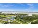 A picturesque aerial view showcasing the riverfront property, its location and surrounding landscape and adjacent properties at 12581 Eisenhower Dr, Port Charlotte, FL 33953
