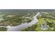 High angle shows the property between winding waterways and lush greenery at 12581 Eisenhower Dr, Port Charlotte, FL 33953