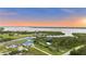 Aerial view of the property highlighting the waterfront location and beautiful landscaping at 12581 Eisenhower Dr, Port Charlotte, FL 33953