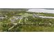 Expansive aerial view of waterfront property showcasing lush greenery and neighborhood at 12581 Eisenhower Dr, Port Charlotte, FL 33953