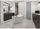 Luxurious bathroom with freestanding tub, marble tile accent wall, and dark wood cabinets at 12581 Eisenhower Dr, Port Charlotte, FL 33953