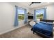 Bedroom with blue accents, two windows, a work station and carpet at 12581 Eisenhower Dr, Port Charlotte, FL 33953