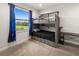 Bedroom with a bunk bed, desk, and natural light from a large window at 12581 Eisenhower Dr, Port Charlotte, FL 33953