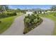 Circular driveway featuring an island with manicured landscaping, adding curb appeal to the property at 12581 Eisenhower Dr, Port Charlotte, FL 33953