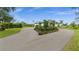Gorgeous single-Gathering home with beautiful landscaping, lush lawn and circular driveway at 12581 Eisenhower Dr, Port Charlotte, FL 33953