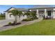Charming home showcasing a stone walkway, manicured landscaping, and a welcoming front entrance with double doors at 12581 Eisenhower Dr, Port Charlotte, FL 33953