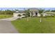 Attractive single-Gathering home featuring lush green lawn and mature palm trees, enhancing curb appeal at 12581 Eisenhower Dr, Port Charlotte, FL 33953