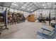 A well-organized garage interior with storage racks, bicycles, furniture, and equipment, providing ample space for hobbies and projects at 12581 Eisenhower Dr, Port Charlotte, FL 33953