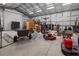 A spacious garage interior with tools, equipment, and storage, offering ample space for projects and storage of machinery at 12581 Eisenhower Dr, Port Charlotte, FL 33953