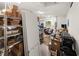 Spacious garage featuring ample storage shelving and a comfortable seating area at 12581 Eisenhower Dr, Port Charlotte, FL 33953
