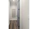 Hallway featuring luxury vinyl plank flooring, light gray walls and a decorative wall hanging at 12581 Eisenhower Dr, Port Charlotte, FL 33953