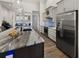 Spacious kitchen featuring stainless steel appliances, marble countertops, and gray cabinetry at 12581 Eisenhower Dr, Port Charlotte, FL 33953