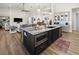 Open-concept kitchen island with seating, microwave, and views of living area at 12581 Eisenhower Dr, Port Charlotte, FL 33953