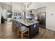 Bright kitchen with gray cabinets, a large island with seating, and modern pendant lighting at 12581 Eisenhower Dr, Port Charlotte, FL 33953