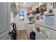 Bright laundry room featuring modern appliances and ample shelving for storage at 12581 Eisenhower Dr, Port Charlotte, FL 33953