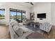 Bright living room features hardwood floors, comfortable seating, and a large sliding glass door with backyard views at 12581 Eisenhower Dr, Port Charlotte, FL 33953