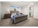 Light-filled main bedroom with plush carpeting, a tray ceiling, and scenic water views at 12581 Eisenhower Dr, Port Charlotte, FL 33953