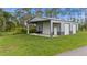 Large outbuilding with roll-up doors for workshop or storage; surrounded by green lawn at 12581 Eisenhower Dr, Port Charlotte, FL 33953