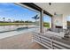 Relaxing outdoor patio with seating, a pool, and scenic waterfront views at 12581 Eisenhower Dr, Port Charlotte, FL 33953