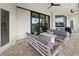 Stylish outdoor patio with comfortable seating, a fire pit, and scenic backyard views at 12581 Eisenhower Dr, Port Charlotte, FL 33953