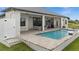 A view of the private in-ground pool and patio area featuring lounge chairs and an outdoor seating area at 12581 Eisenhower Dr, Port Charlotte, FL 33953