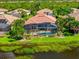 A scenic house with a screened pool area, enveloped by palms and overlooking a tranquil waterway at 13136 N Marsh Dr, Port Charlotte, FL 33953