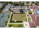 An aerial view showcases community green spaces, and tennis courts near building at 13136 N Marsh Dr, Port Charlotte, FL 33953