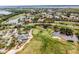 Community aerial shot featuring the golf course, lakes, and lush surroundings at 13136 N Marsh Dr, Port Charlotte, FL 33953