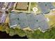 Aerial view features tennis courts surrounded by greenery, offering a glimpse of community amenities at 13136 N Marsh Dr, Port Charlotte, FL 33953