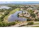 Community aerial view highlighting serene lakefront properties and the scenic golf course at 13136 N Marsh Dr, Port Charlotte, FL 33953