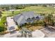 Aerial shot of the clubhouse and golf course showcasing manicured greens, lush landscaping, and elegant architectural design at 13136 N Marsh Dr, Port Charlotte, FL 33953