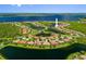 An aerial view shows a lakeside community with well-maintained homes and lush landscaping at 13136 N Marsh Dr, Port Charlotte, FL 33953