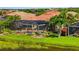 Lakeside home featuring a screened pool, scenic waterway views, and lush landscaping at 13136 N Marsh Dr, Port Charlotte, FL 33953