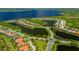 Aerial view of a residential community with waterfront properties and lush greenery at 13136 N Marsh Dr, Port Charlotte, FL 33953