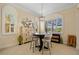 Inviting breakfast nook featuring a round table, three stools, and view of backyard at 13136 N Marsh Dr, Port Charlotte, FL 33953