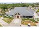 Stunning clubhouse exterior showcasing architectural details, manicured landscaping, and welcoming entrance at 13136 N Marsh Dr, Port Charlotte, FL 33953