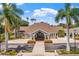 Inviting clubhouse exterior with lush landscaping, brick entryway, and covered entrance, offering a welcoming community focal point at 13136 N Marsh Dr, Port Charlotte, FL 33953