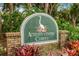 The Activity Center Campus sign surrounded by lush foliage and decorative bromeliads at 13136 N Marsh Dr, Port Charlotte, FL 33953