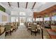 Elegant dining room with high ceilings, ample natural light, and a stylish bar area creating a sophisticated ambiance at 13136 N Marsh Dr, Port Charlotte, FL 33953